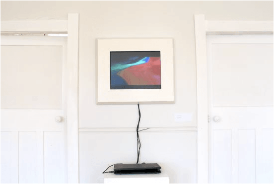 A device connected to a frame with an image inside.