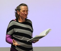 A woman holding an open book.