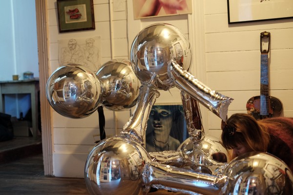 A balloon sculpture inside a room.