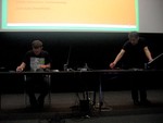 Two people at a desk.