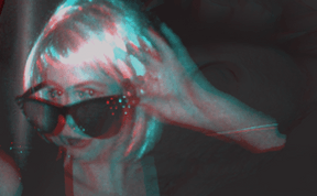 A woman in a wig wearing sunglasses.