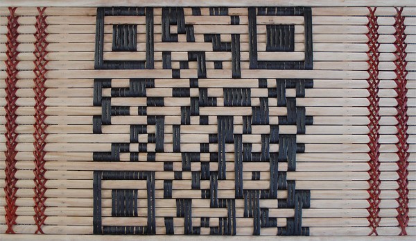 A woven artwork of a QR code.