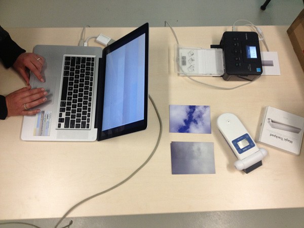 A laptop and other devices on a table.