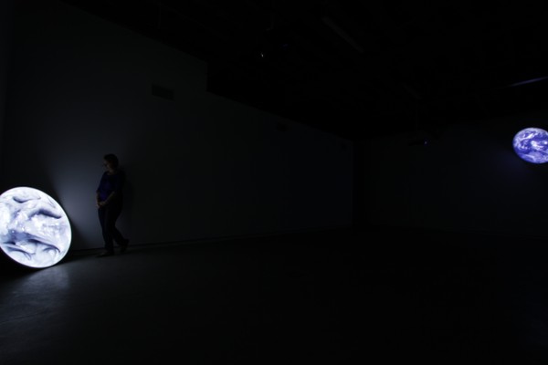 Two glowing circles in a dark room.