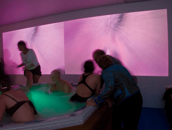 A group of humans in a hot tub.