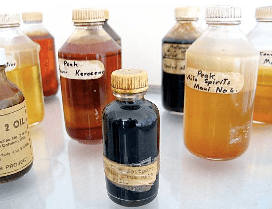 A collection of bottles with colourful liquid inside.